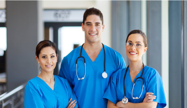 three nurses in blue scrubs